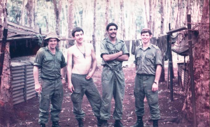 George Anderson and mates near their hut in Vietnam